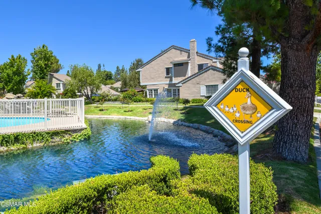 a view of a house with pool and chairs