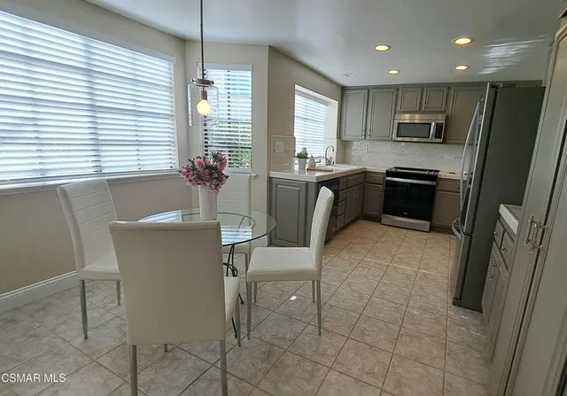 a kitchen with a table and chairs