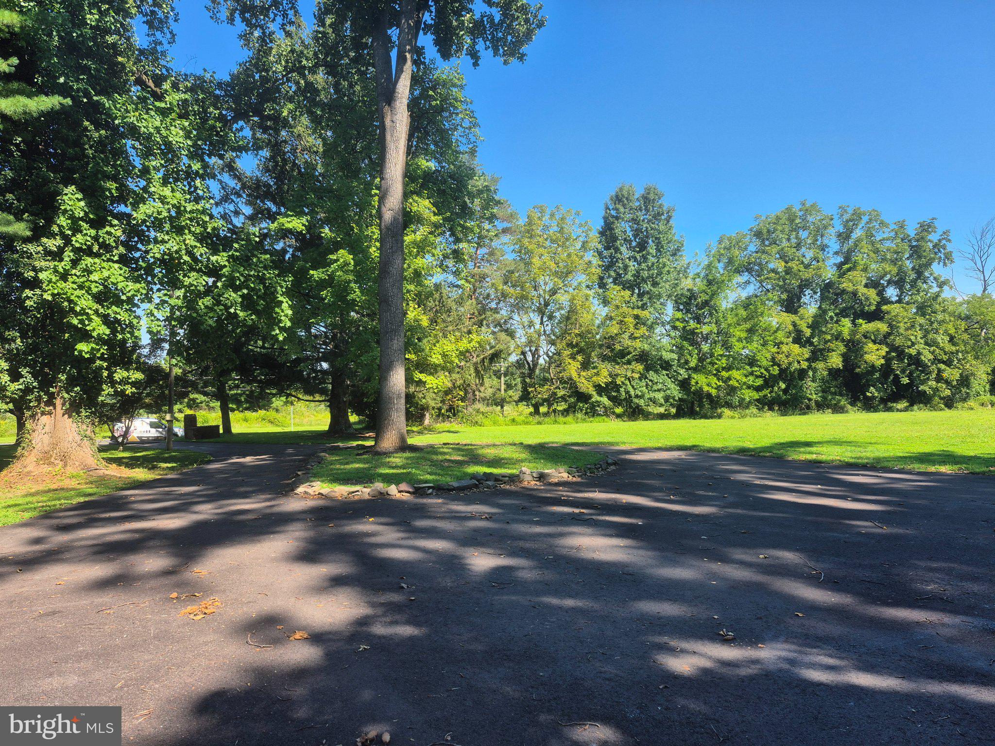 1305 Twining Road Dresher, PA 19025 - Photo 16 of 75 Serene green space under blue skies.