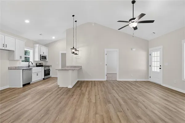 a view of kitchen with wooden floor and window