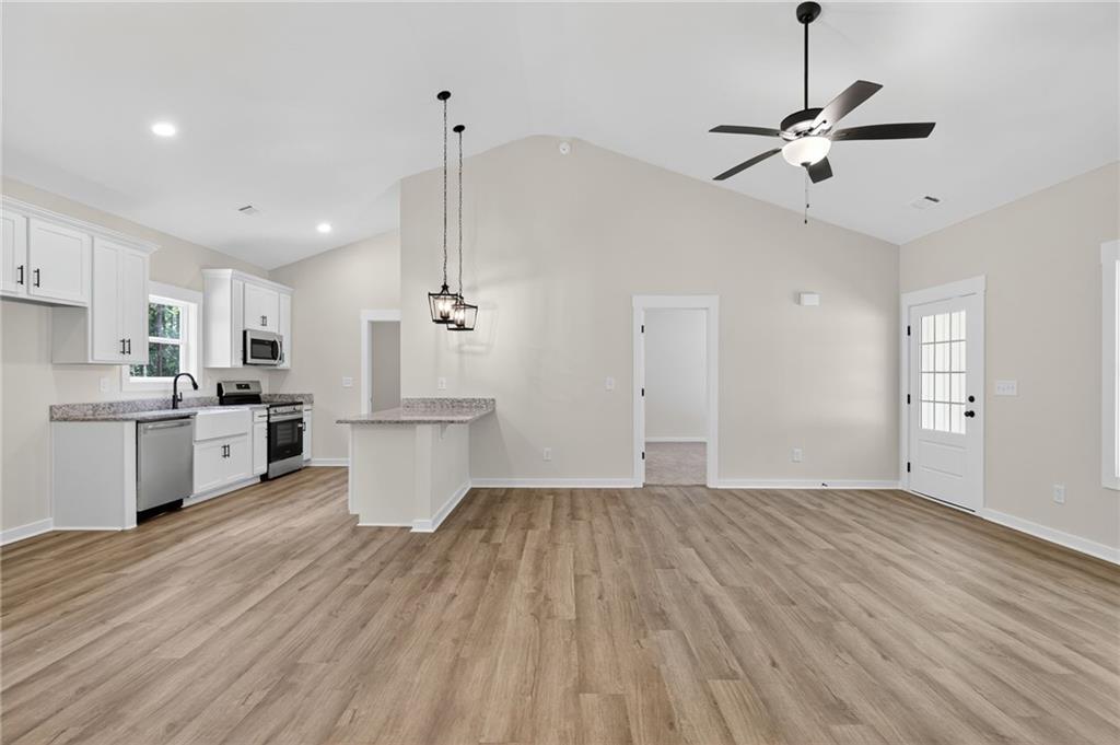 5534 Steadman Road Buchanan, GA 30113 - Photo 13 of 40 a view of kitchen with wooden floor and window