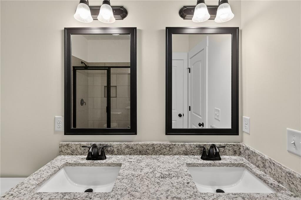 5534 Steadman Road Buchanan, GA 30113 - Photo 23 of 40 a bathroom with double vanity sinks and a vanity