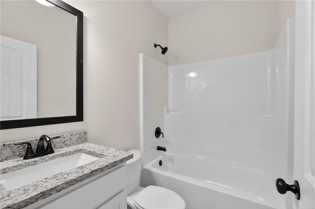 5534 Steadman Road Buchanan, GA 30113 - Photo 25 of 40 a bathroom with a granite countertop sink toilet and shower