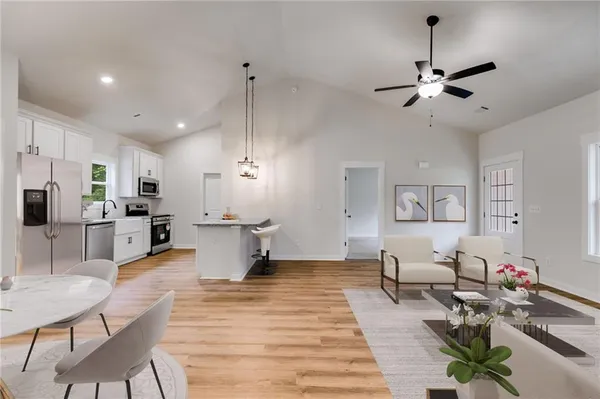 a living room with furniture and kitchen view