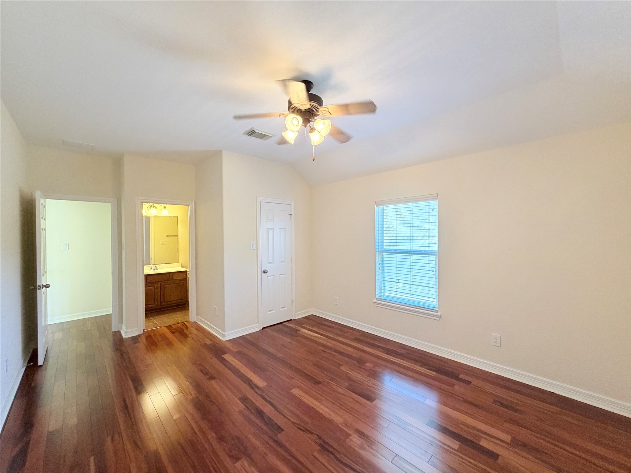 28015 Silverstream Court Fulshear, TX 77441 - Photo 25 of 33 an empty room with wooden floor and windows