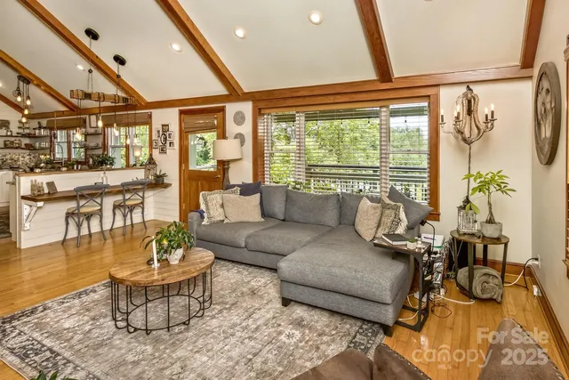 a kitchen with stainless steel appliances a sink cabinets and a large window