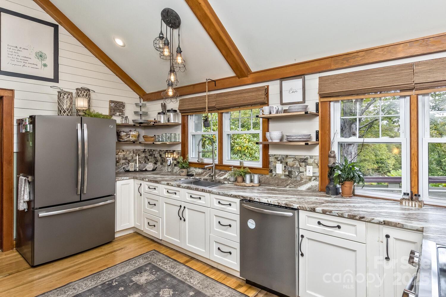 25 View Ridge Parkway Leicester, NC 28748 - Photo 15 of 47 a kitchen with stainless steel appliances a sink cabinets and a large window