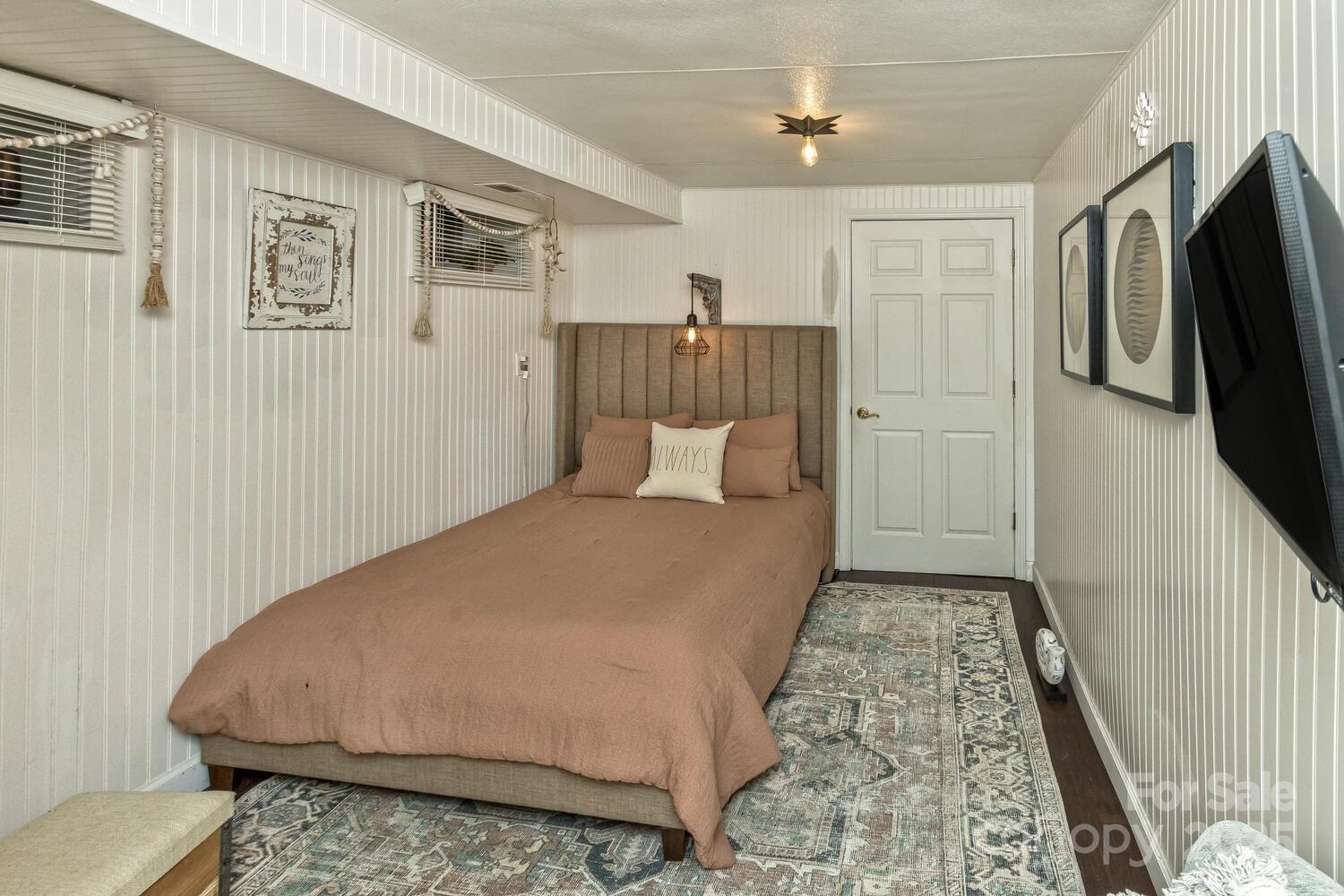 25 View Ridge Parkway Leicester, NC 28748 - Photo 26 of 47 a bedroom with a bed and a flat screen tv