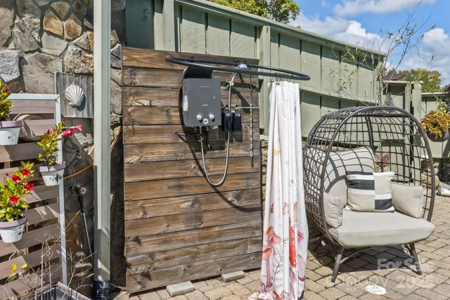 a view of a house with swimming pool and sitting area