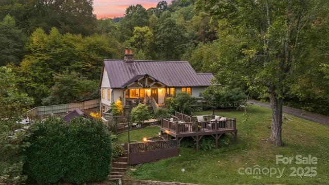 an aerial view of a house with swimming pool and outdoor seating