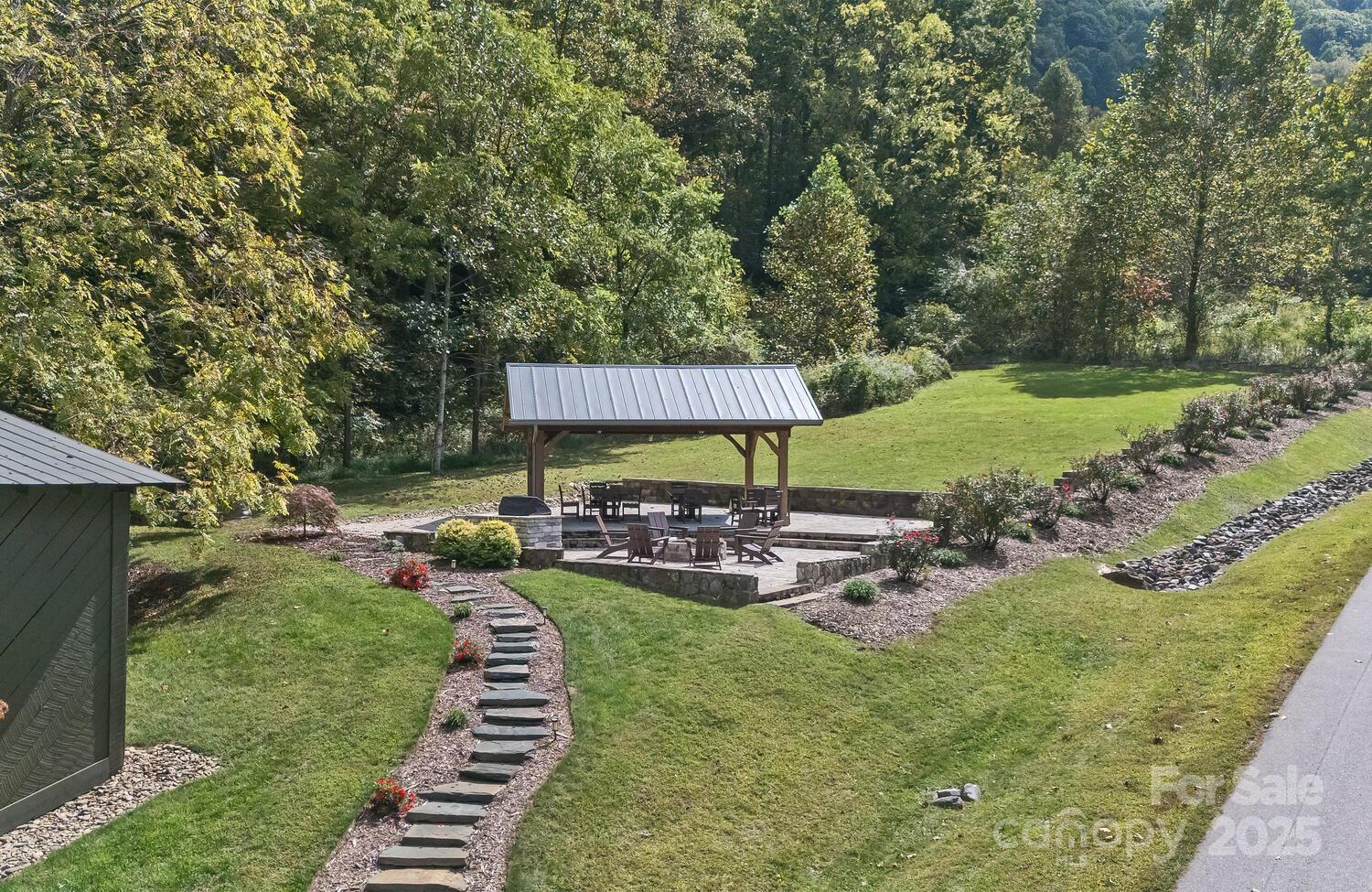 25 View Ridge Parkway Leicester, NC 28748 - Photo 46 of 47 a view of a patio with table and chairs under an umbrella
