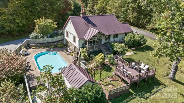 an aerial view of a house with garden space and street view