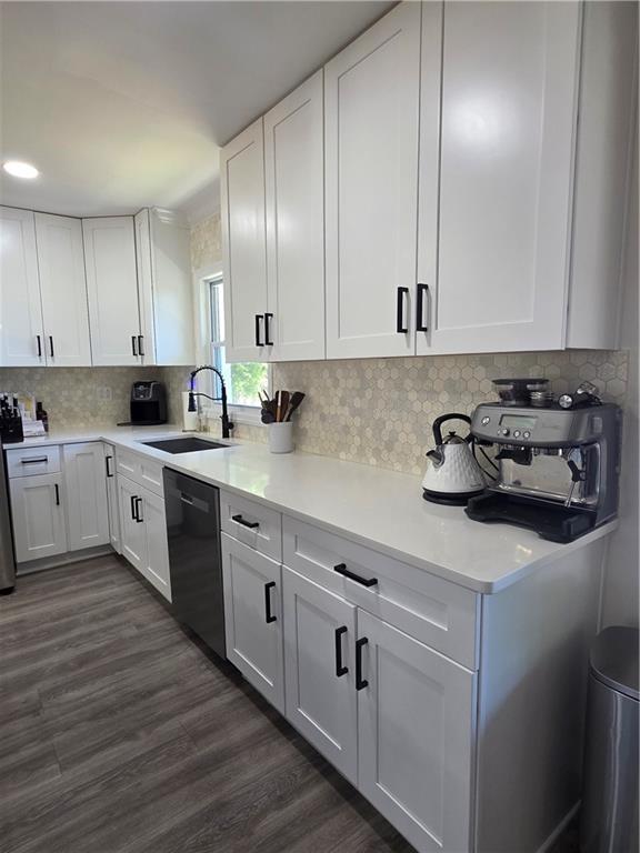 150 Sims Street Winder, GA 30680 - Photo 18 of 61 a kitchen with cabinets a sink and appliances