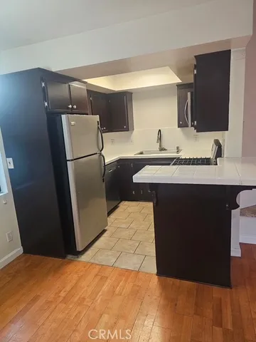 a kitchen with a sink a refrigerator freezer a washer and dryer