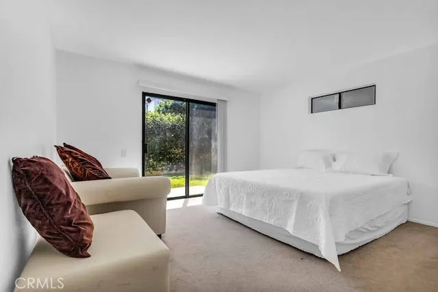 a bedroom with a bed and glass window