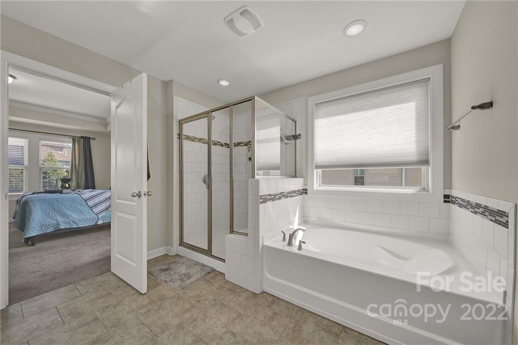 1557 Hazel Street Tega Cay, SC 29708 - Photo 36 of 47 a bathroom with a tub and a shower