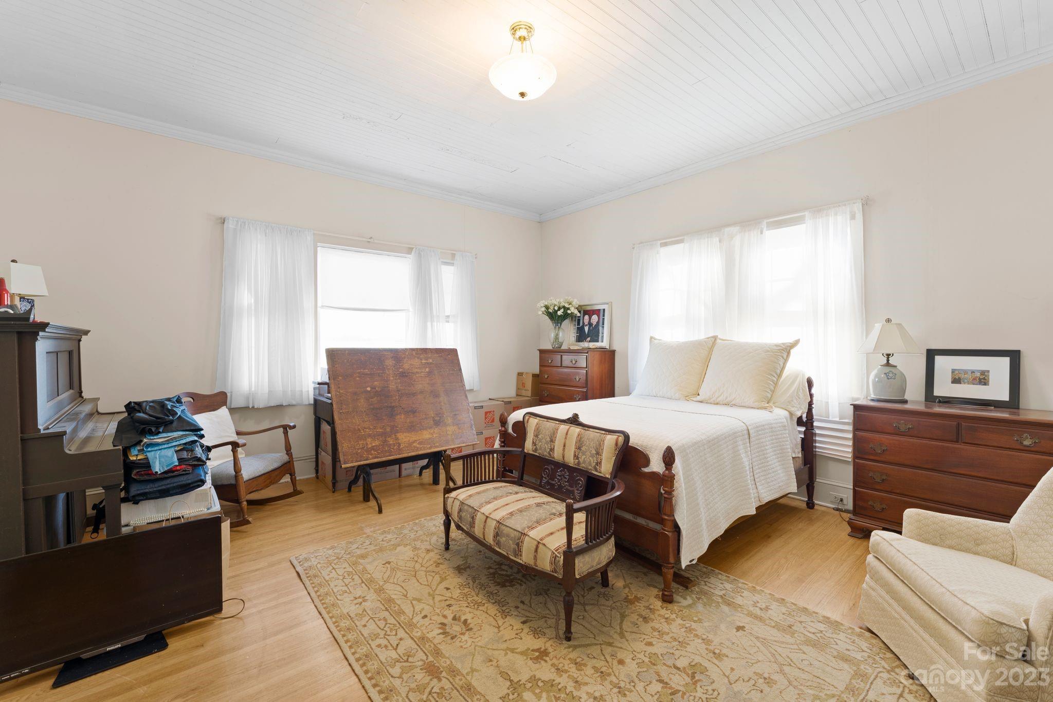 4121 Windy Road Concord, NC 28027 - Photo 12 of 22 a bedroom with a bed wooden floor and window