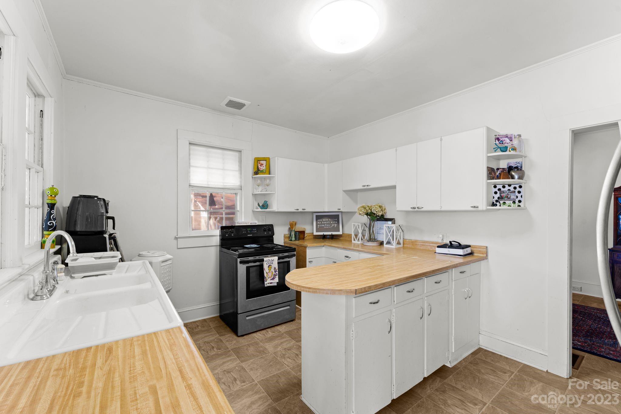 4121 Windy Road Concord, NC 28027 - Photo 10 of 22 a kitchen with a sink stove and refrigerator