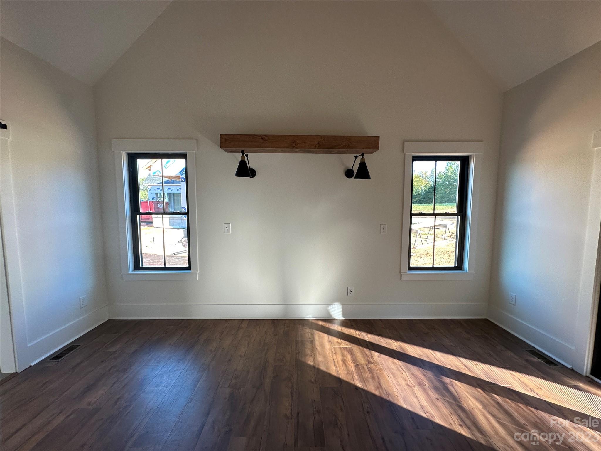 208 Beth Haven Church Road Denver, NC 28037 - Photo 12 of 29 an empty room with wooden floor and windows
