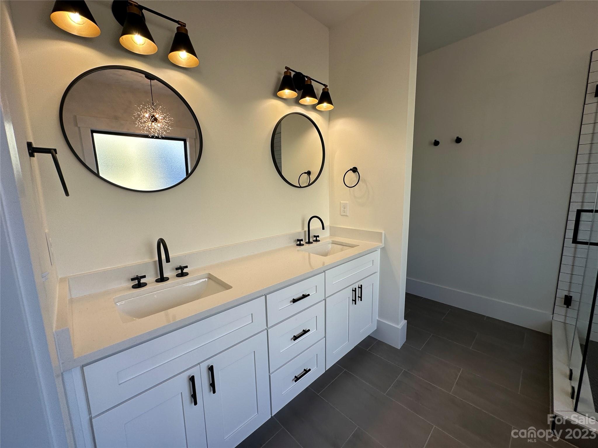 208 Beth Haven Church Road Denver, NC 28037 - Photo 13 of 29 a bathroom with a double vanity sink and a mirror