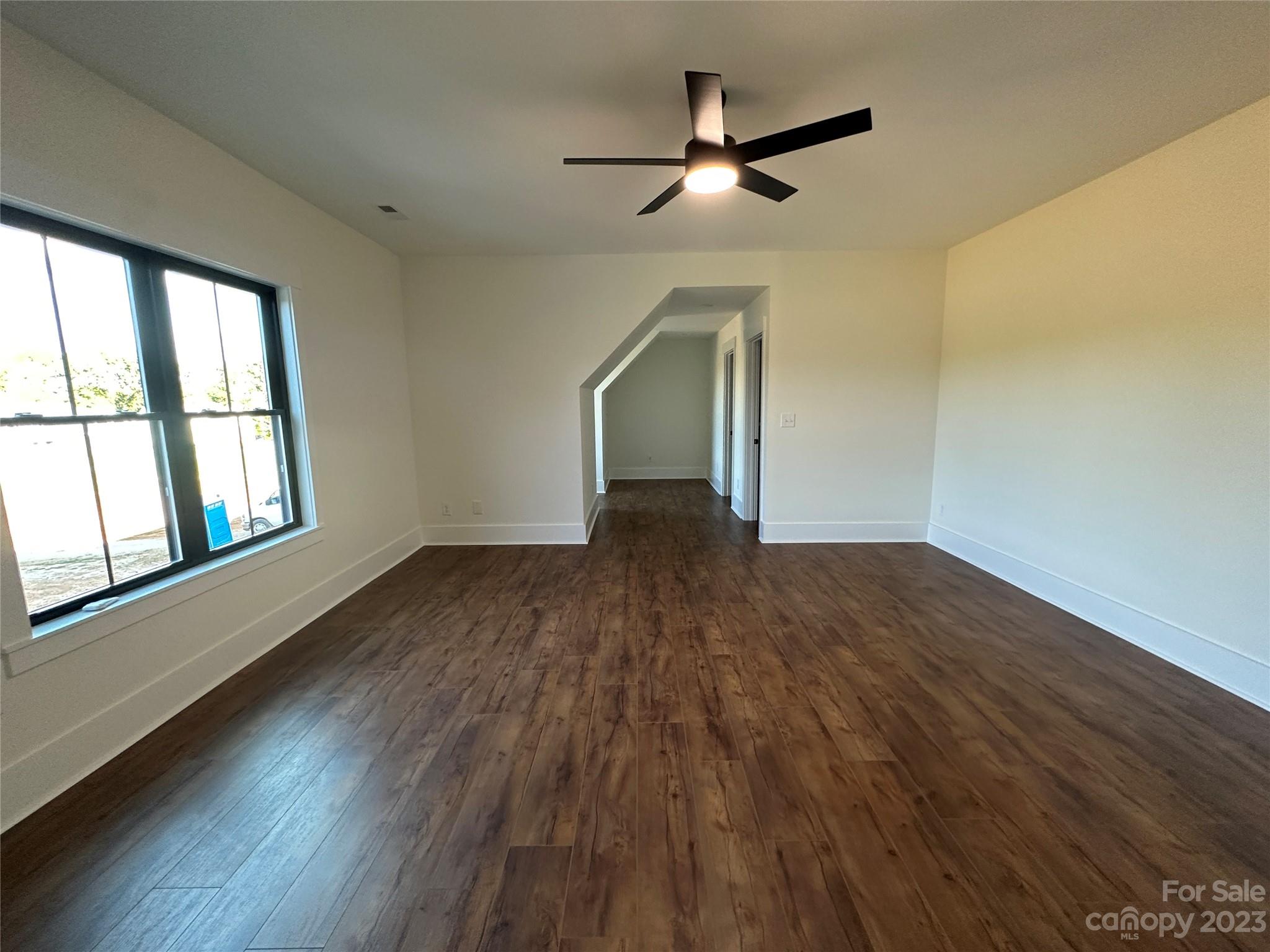 208 Beth Haven Church Road Denver, NC 28037 - Photo 20 of 29 an empty room with wooden floor fan and windows