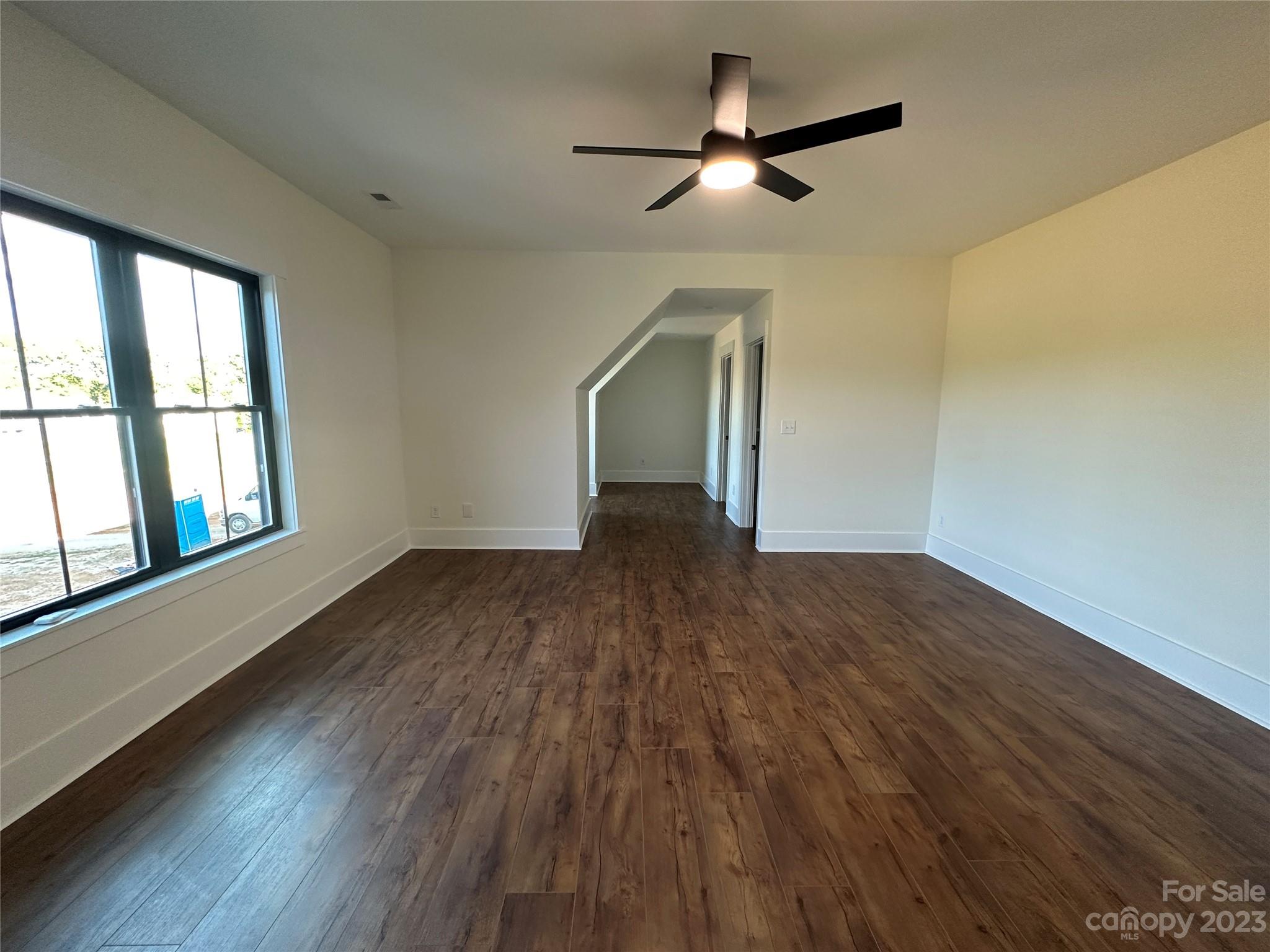 208 Beth Haven Church Road Denver, NC 28037 - Photo 21 of 29 an empty room with wooden floor fan and windows