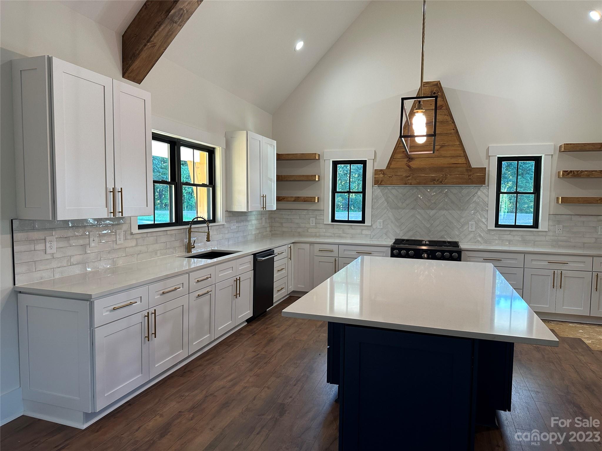 208 Beth Haven Church Road Denver, NC 28037 - Photo 6 of 29 a kitchen with a sink a stove a center island and a cabinets