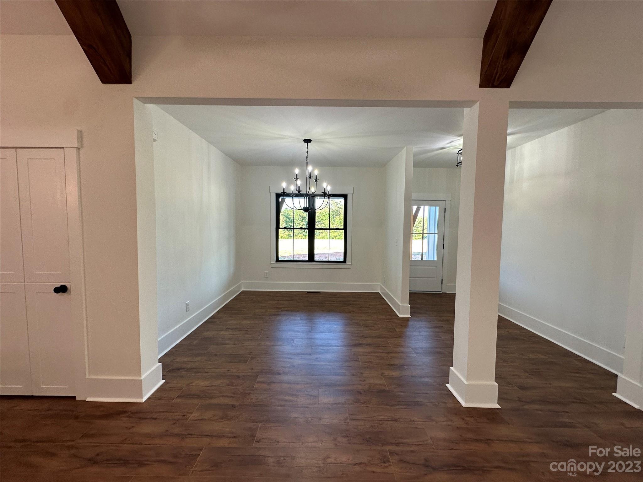 208 Beth Haven Church Road Denver, NC 28037 - Photo 9 of 29 a view of an empty room with wooden floor and a window