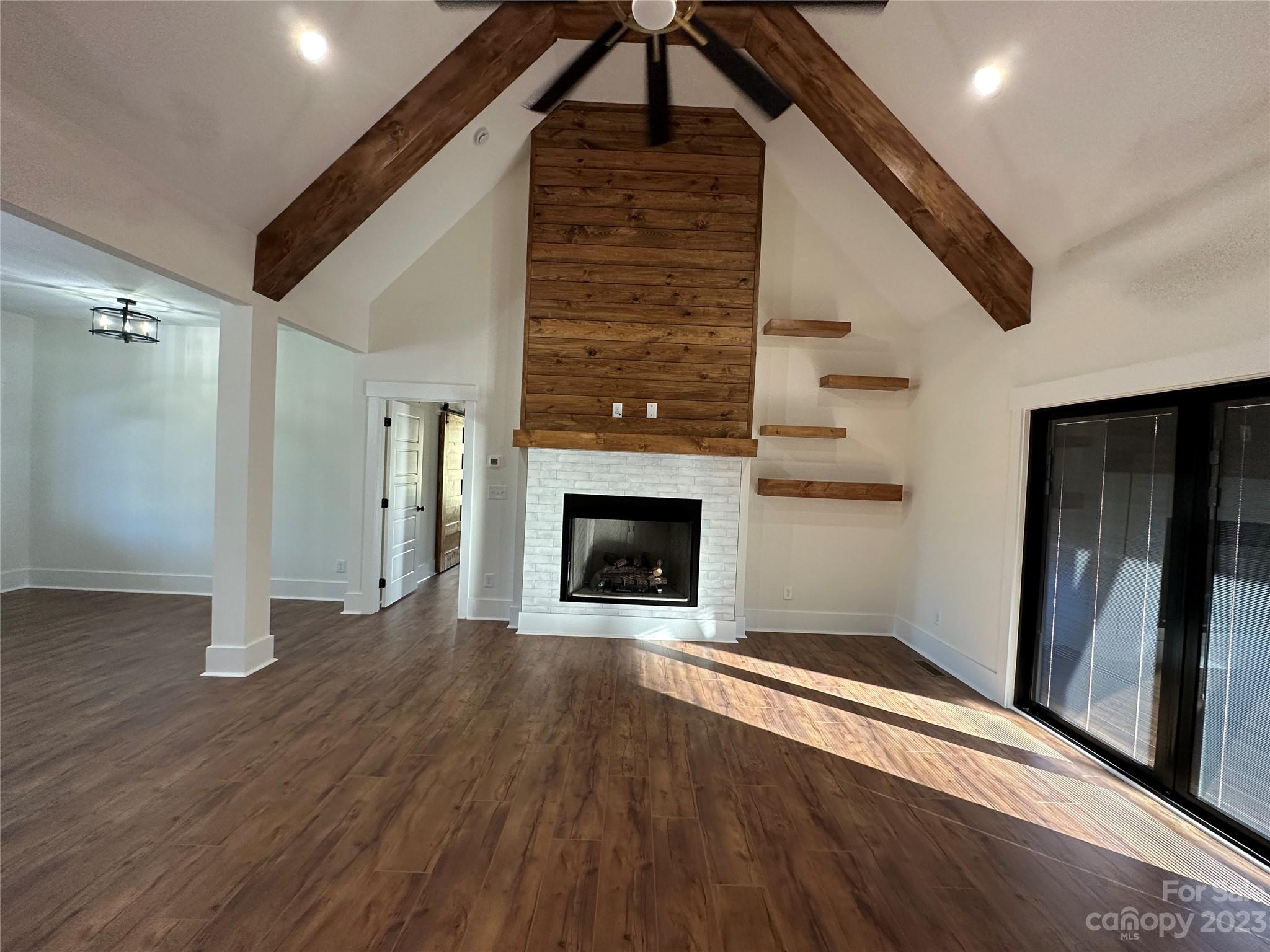 208 Beth Haven Church Road Denver, NC 28037 - Photo 10 of 29 a view of an empty room with wooden floor fireplace and a window