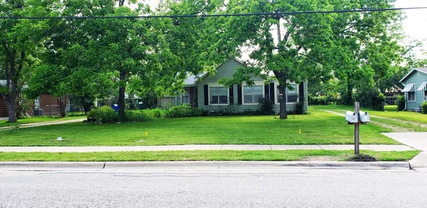 a front view of a house with a yard table and chairs
