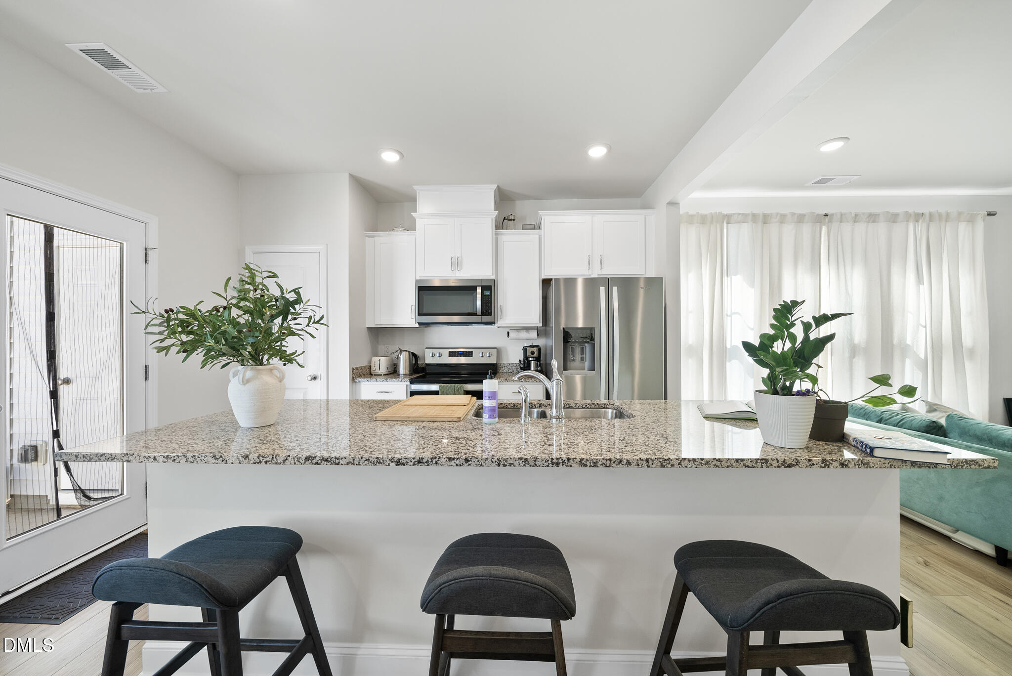 53 Bibury Way Angier, NC 27501 - Photo 12 of 50 a kitchen with stainless steel appliances granite countertop white cabinets a sink and a potted plant