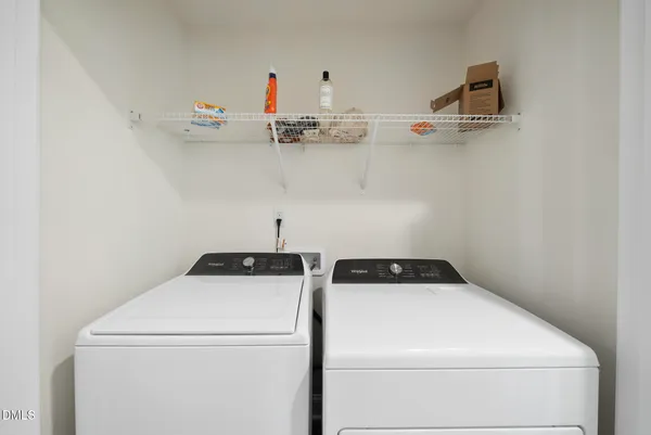 a view of walk in closet with clothes