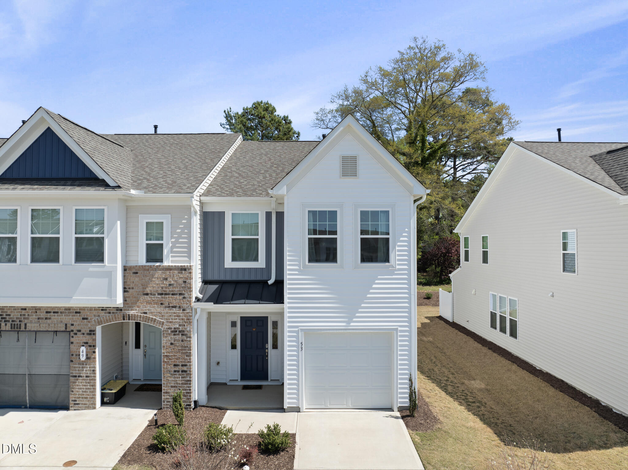 53 Bibury Way Angier, NC 27501 - Photo 35 of 50 a view of a white house with large windows and a small yard