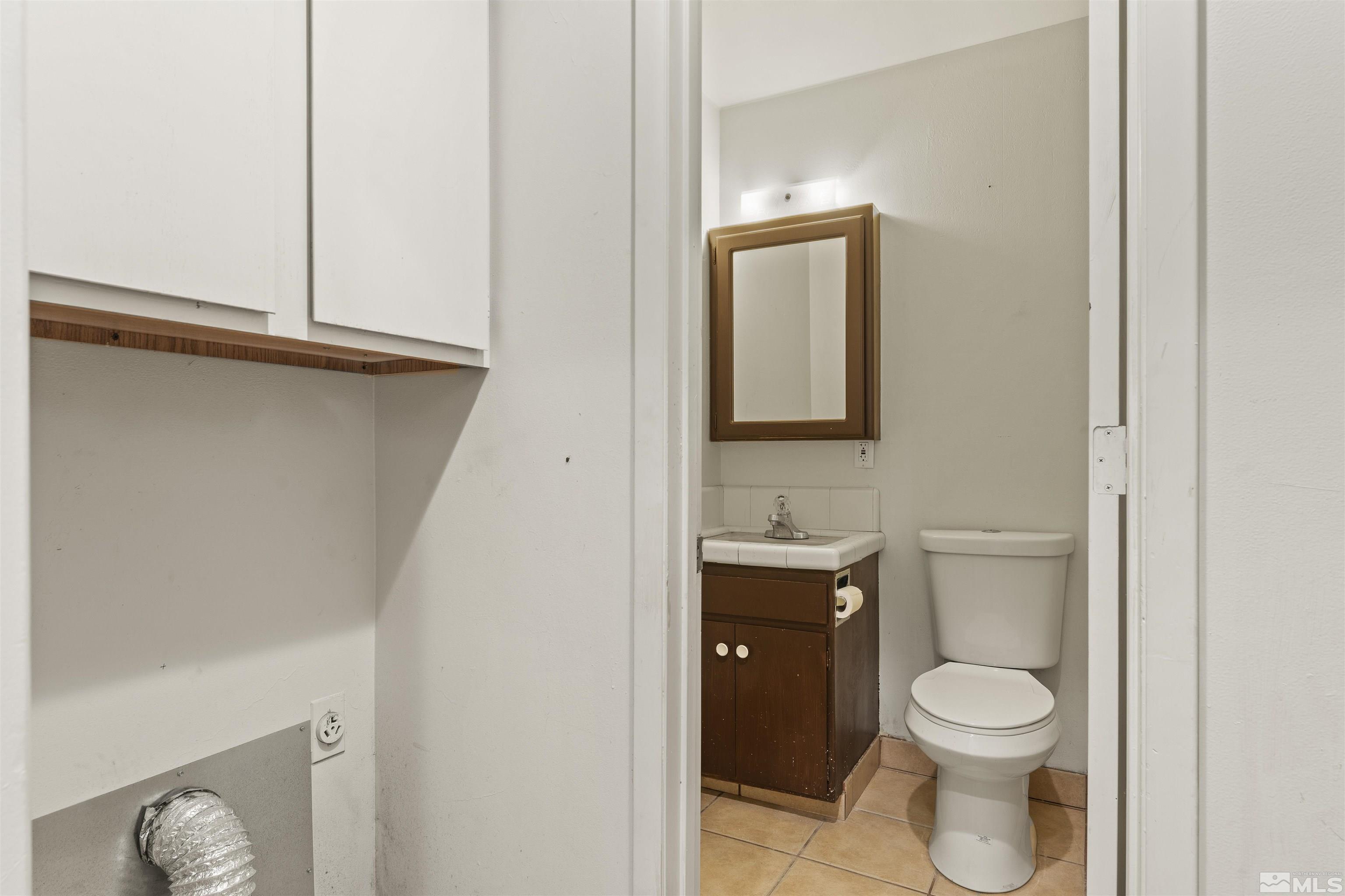 951 Wilkinson Avenue Reno, NV 89502 - Photo 19 of 25 a bathroom with a toilet a sink and mirror