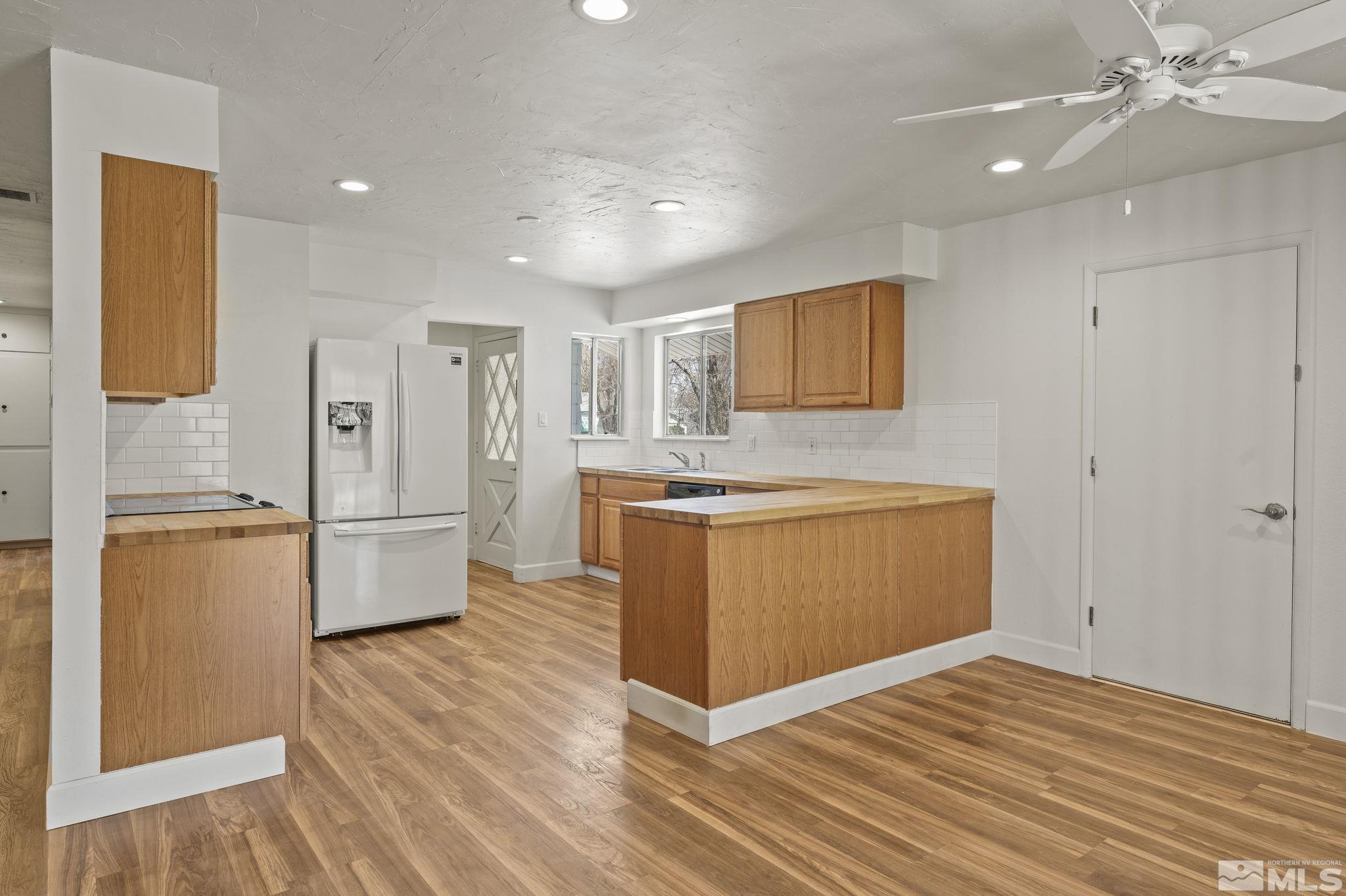 951 Wilkinson Avenue Reno, NV 89502 - Photo 8 of 25 a kitchen with refrigerator cabinets and wooden floor