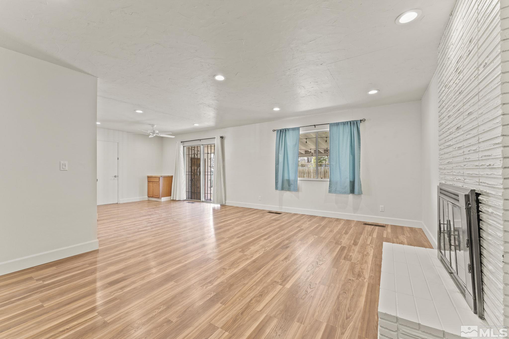 951 Wilkinson Avenue Reno, NV 89502 - Photo 9 of 25 a view of an empty room with wooden floor and a window