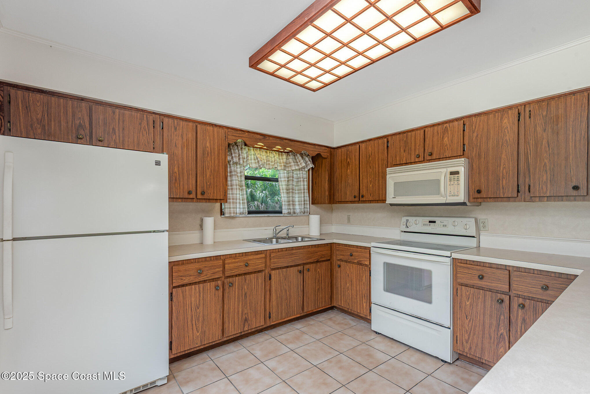 4300 Justa Road Mims, FL 32754 - Photo 14 of 55 a kitchen with a sink a refrigerator and cabinets