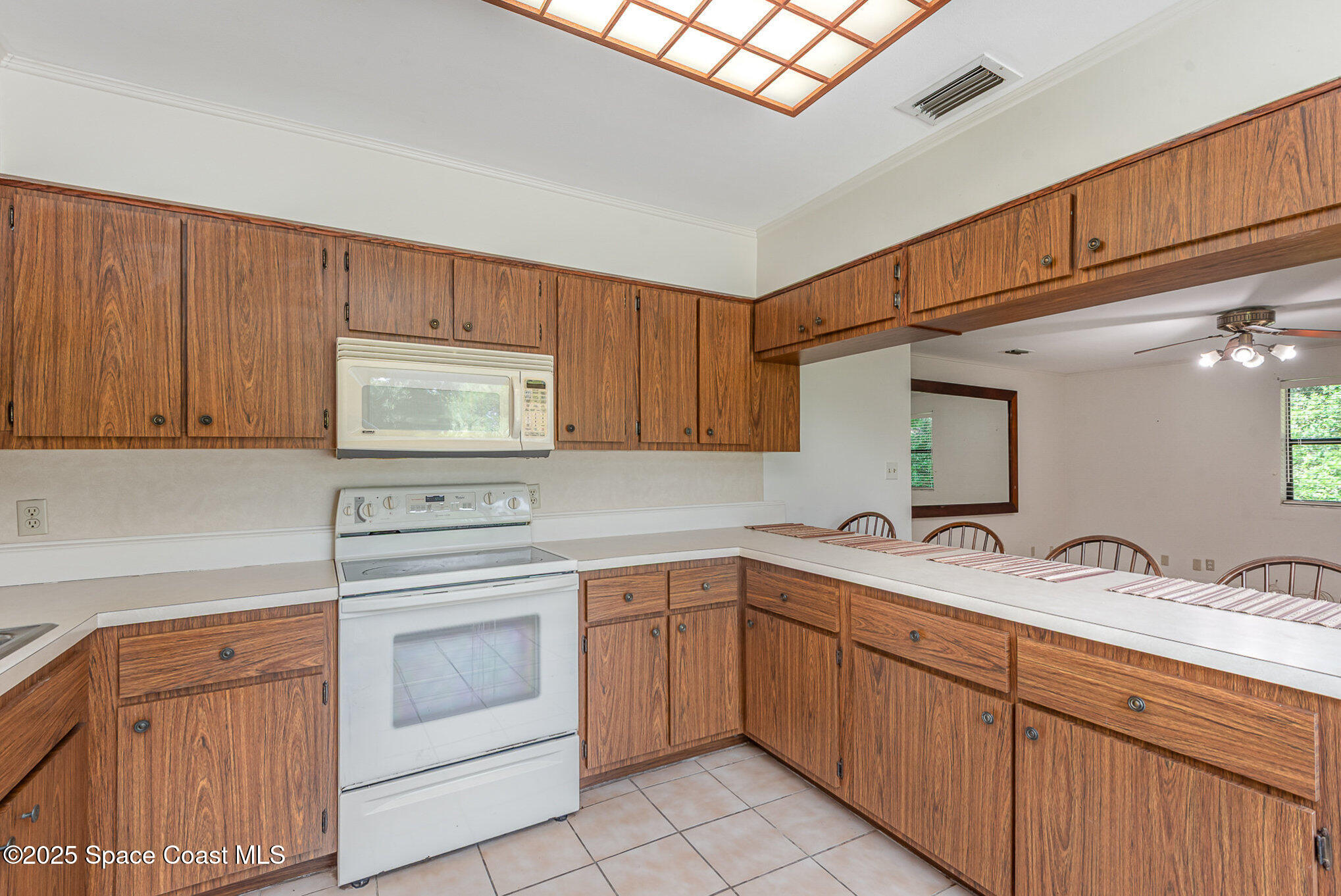 4300 Justa Road Mims, FL 32754 - Photo 15 of 55 a kitchen with sink a stove and cabinets