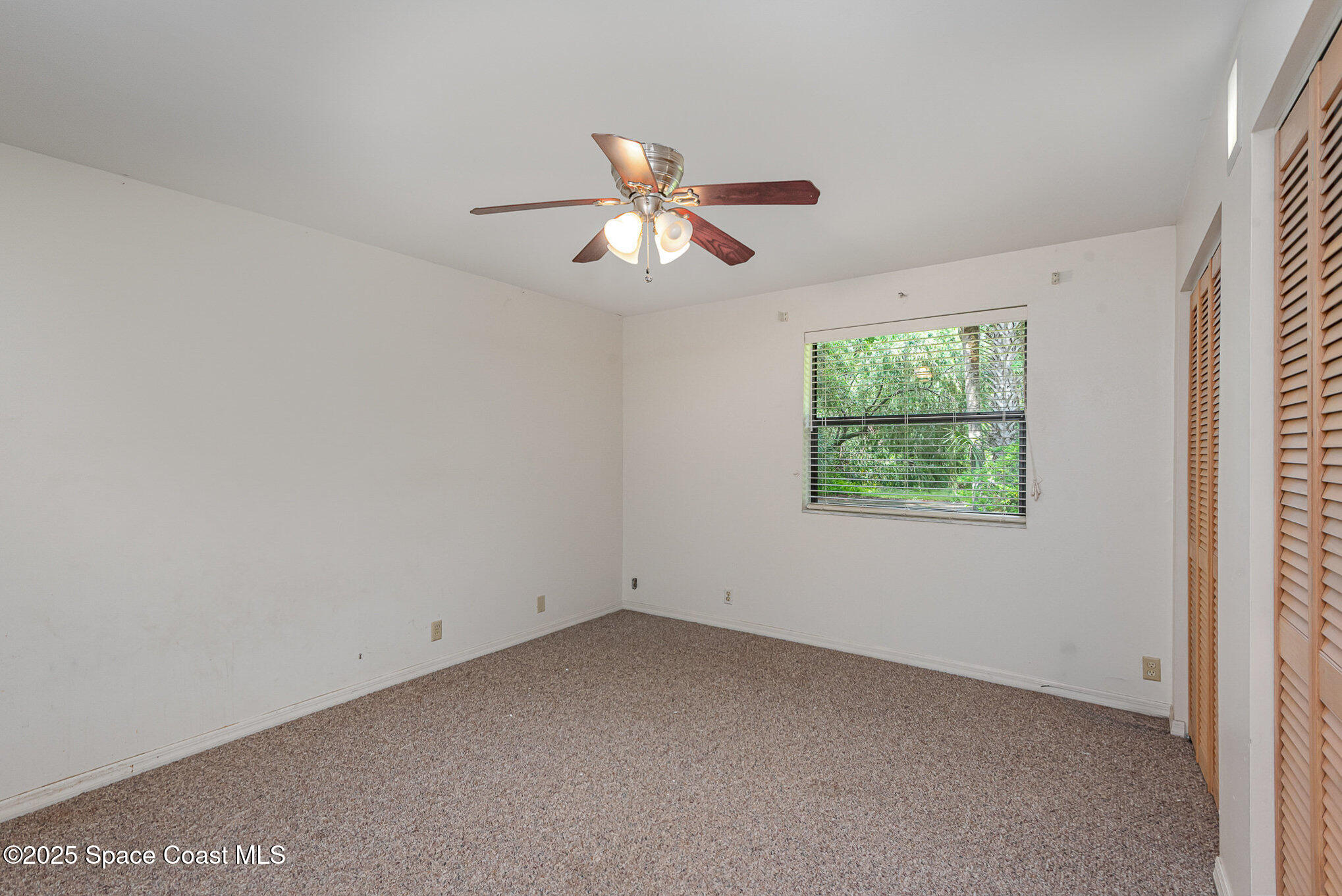 4300 Justa Road Mims, FL 32754 - Photo 16 of 55 an empty room with a window and a fan