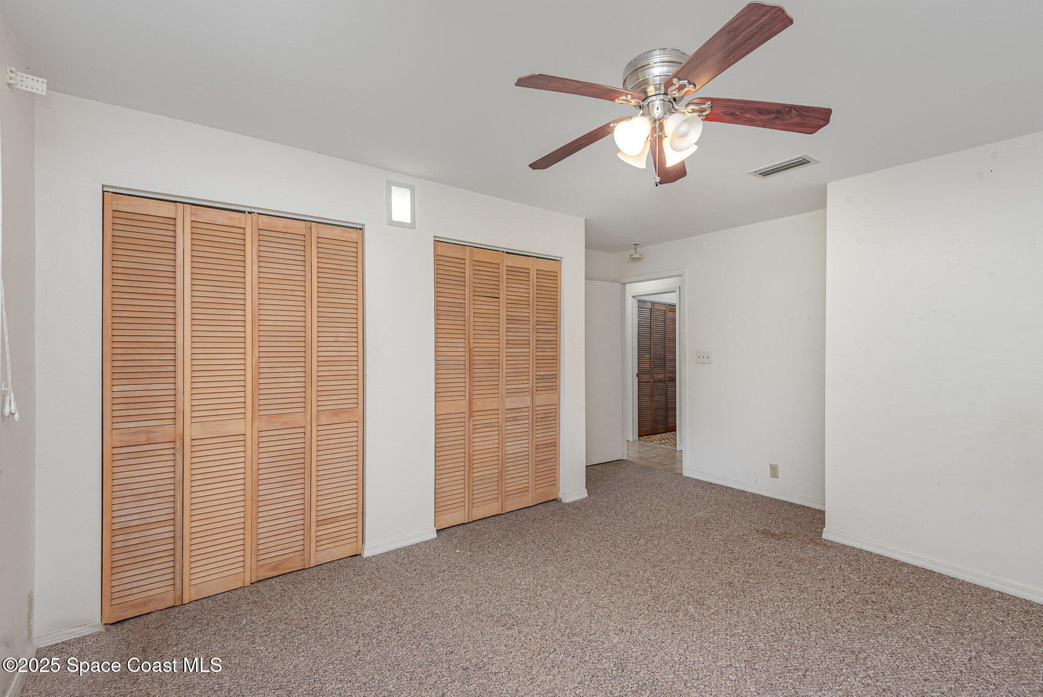 4300 Justa Road Mims, FL 32754 - Photo 17 of 55 an empty room with chandelier fan