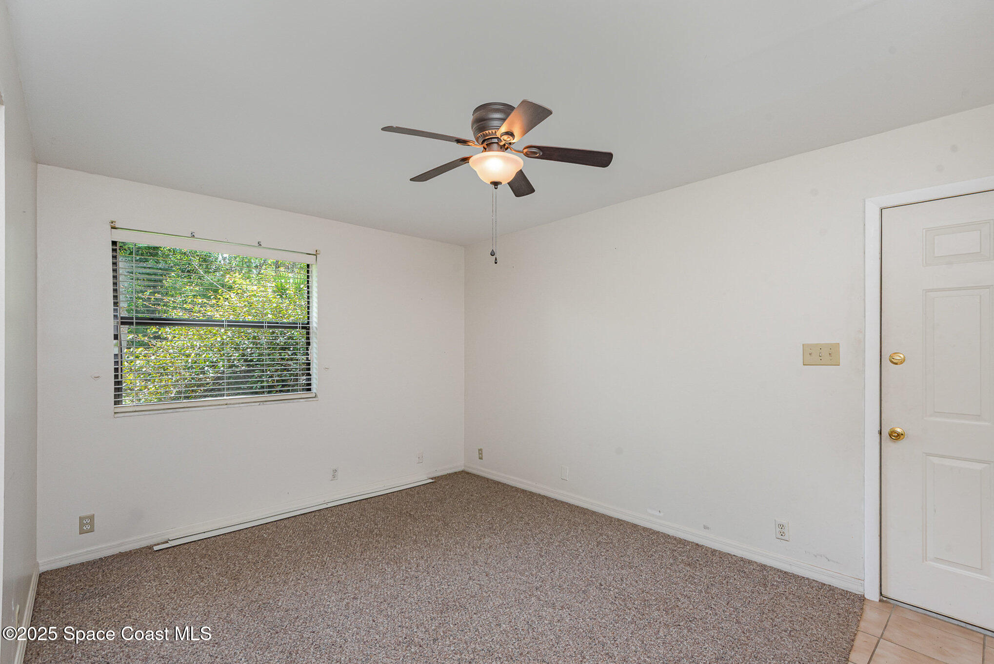 4300 Justa Road Mims, FL 32754 - Photo 18 of 55 a very nice looking room with a ceiling fan and a window