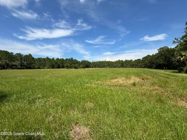 a view of a lake with houses in the background