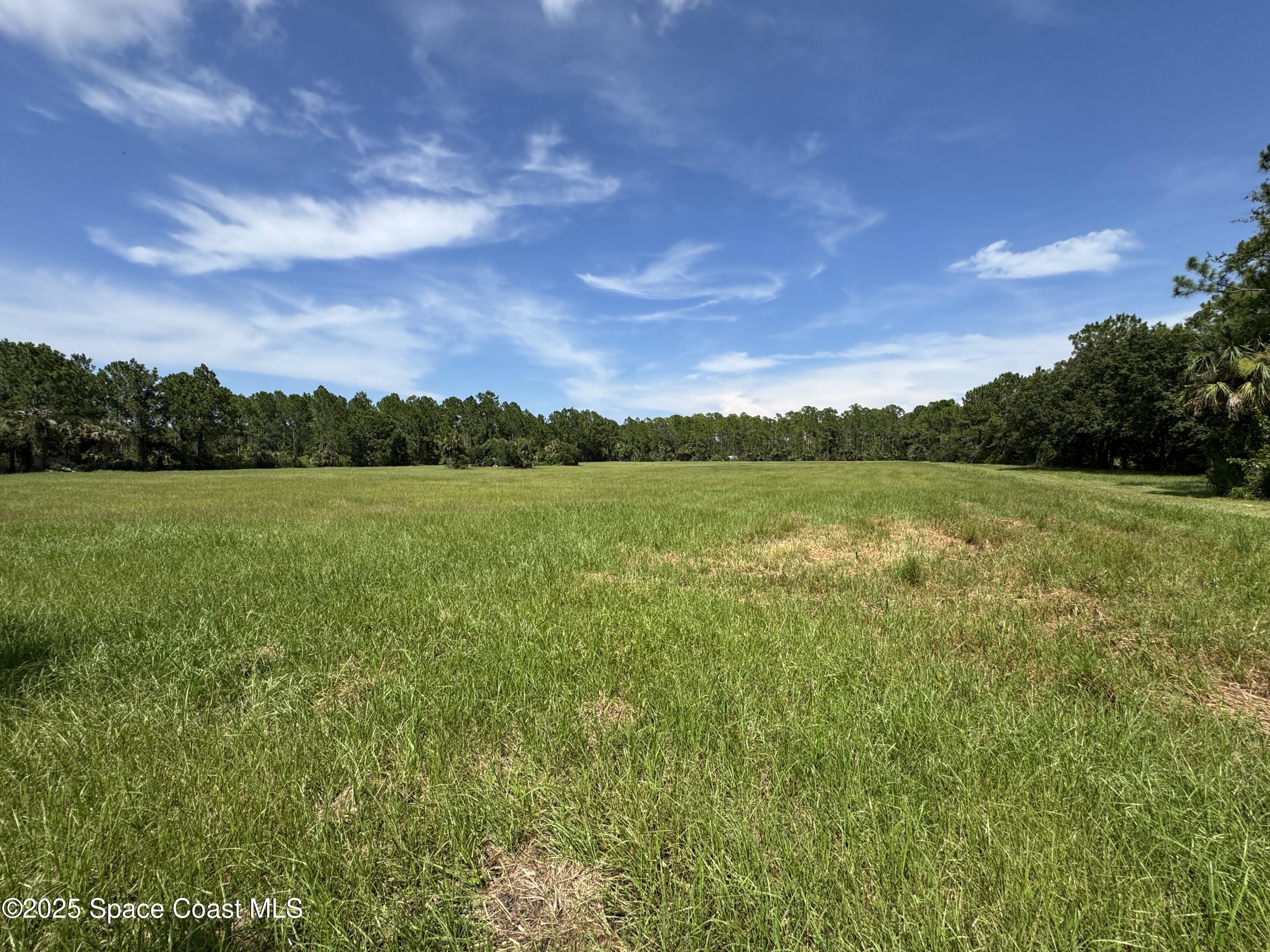 4300 Justa Road Mims, FL 32754 - Photo 7 of 55 a view of a lake with houses in the background