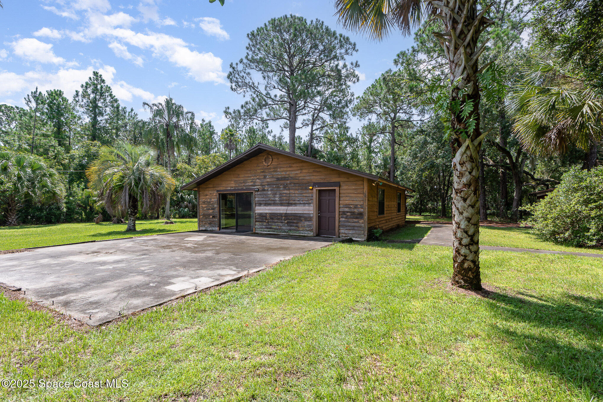 4300 Justa Road Mims, FL 32754 - Photo 8 of 55 a house with trees in the background