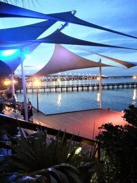 a view of a house with pool and chairs