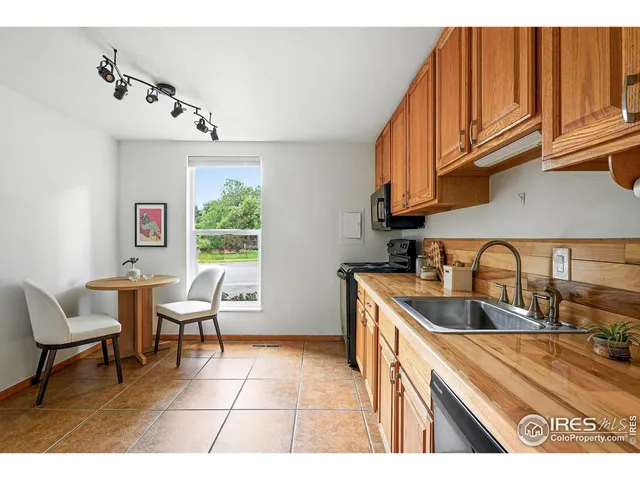 a kitchen with granite countertop a sink and cabinets