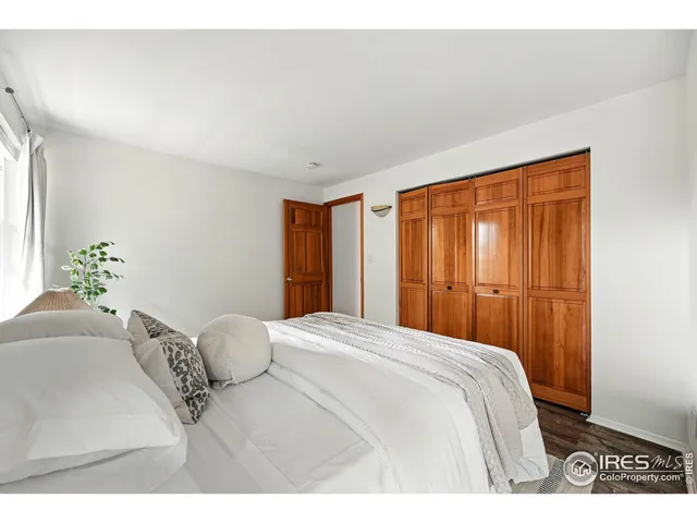 a bedroom with a large bed and a closet