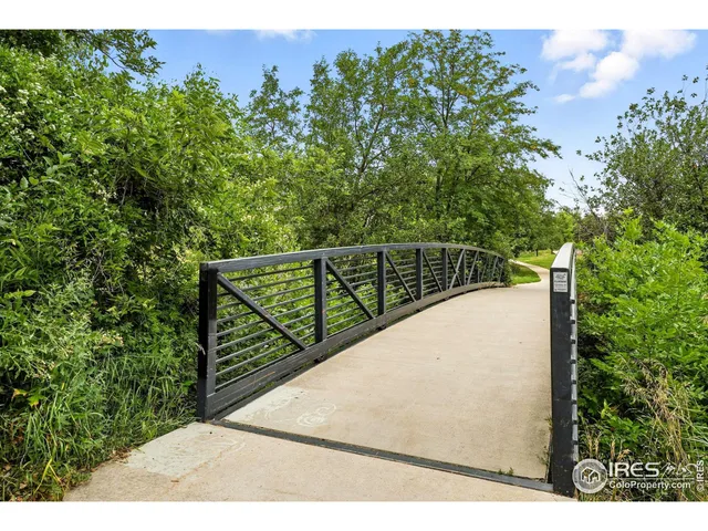 a view of a balcony with wooden floor and a forest
