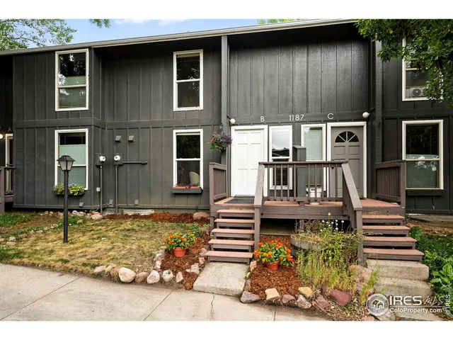 a view of a house with backyard water fountain and sitting area