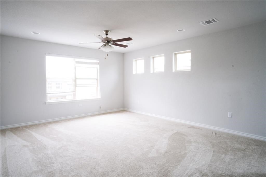 14110 McCoy Loop Austin, TX 78717 - Photo 11 of 35 an empty room with windows and fan